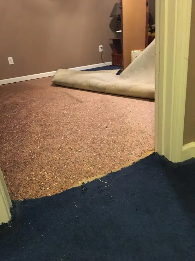 Carpet pad removal revealing water damage during Drying & Dehumidification in Gonzales